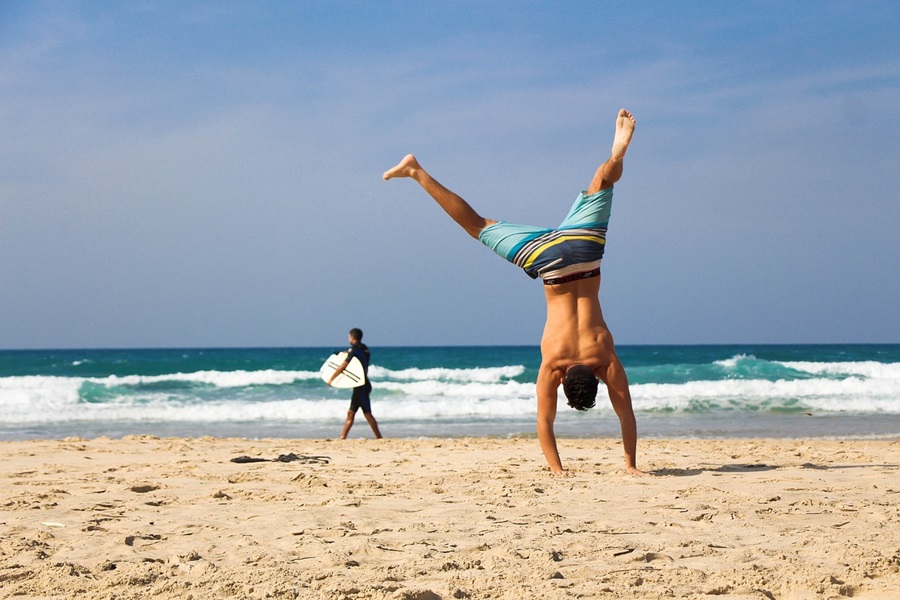 Standard Process Congaplex a Man Doing a Cartwheel on a Beach