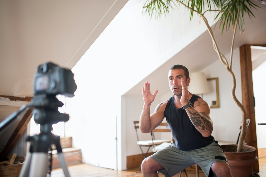 Weekly Jillian Michaels Workout Routines a Man Doing a Workout with a Camera Recording Him Inside a Room with a House Plant in the Background