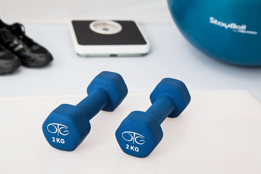 Weekly Jillian Michaels Workout Routines Close Up of Two Dumbbells, a Scale, and a Yoga Ball