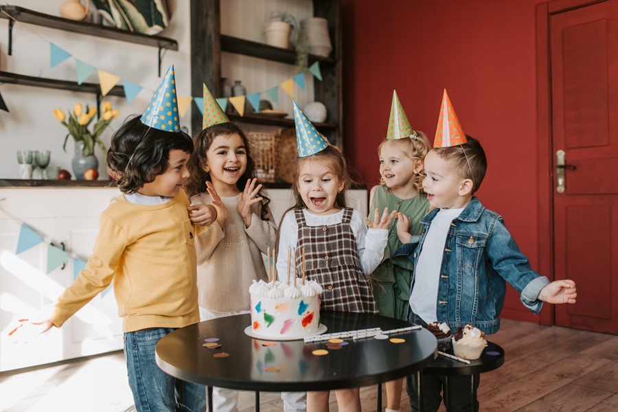 How to Set a Table for your Child's Birthday Party a Group of Kids Around a Small Table Singing Happy Birthday