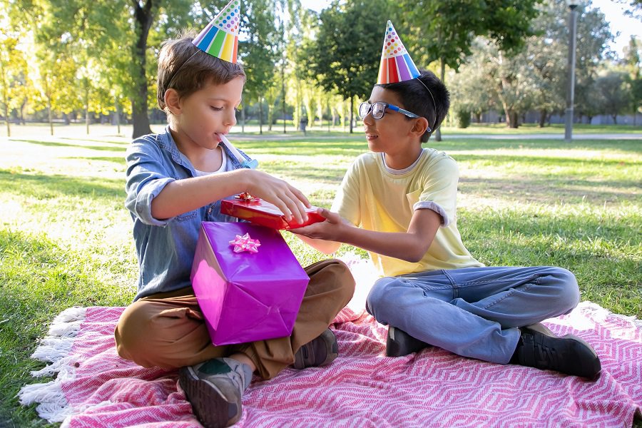 How to Set a Table for your Child's Birthday Party Two Kids Exchanging Gifts Outside in a Park