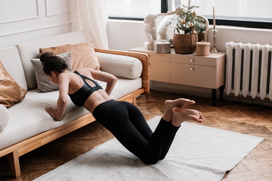 Home Workout a Woman Doing Pushups Using a Couch 