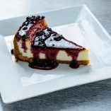 This delicious White Chocolate Brandy Cheesecake Recipe is amazing and a favorite dessert recipe for many, especially when entertaining! Romantic Dessert Recipes | Romantic Recipes | Recipes for Couples | Valentine’s Day Recipes | How to Make Cheesecake | How to Make Cake