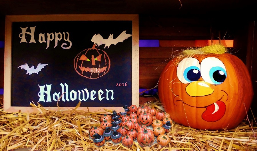Downloads for your Halloween Playlist Painted Pumpkin Next to a Happy Halloween Sign