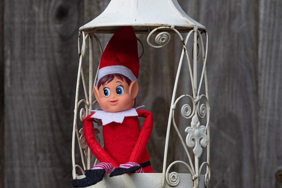 Introduce Elf on the Shelf Close Up of an Elf Sitting in an Empty Lantern Shell