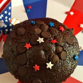 4th of July Recipes Close Up of a Chocolate Chip Muffin with Red, White, and Blue Stars Sprinkled On Top
