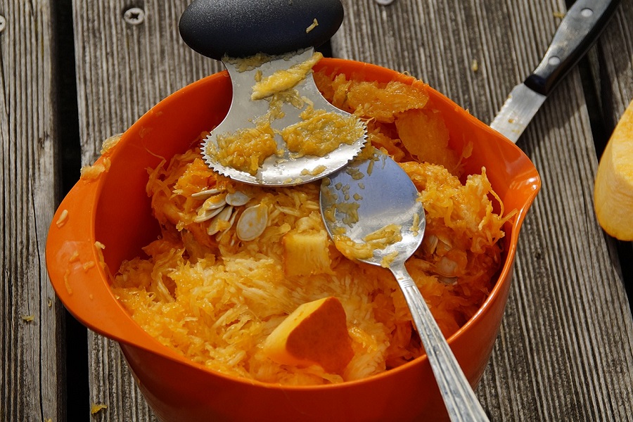 Free DIY Pumpkin Stencils Close Up of an Orange Bucket Filled with Pumpkin Fibrous Strands and Pumpkin Seeds