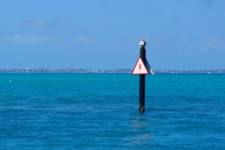 Random Facts About Turks and Caicos View of a Sign Out in the Ocean on a Wooden Post