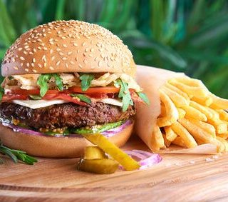 Best Burger Recipes Close Up of a Burger and Fries on a Wooden Surface