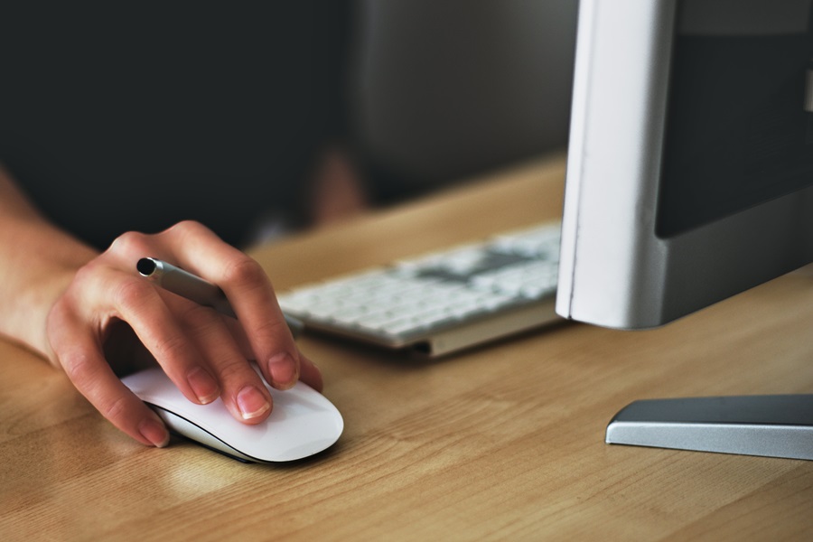 Microsoft Sway Tutorial Close Up of a Person's hand on a Mouse at a Computer