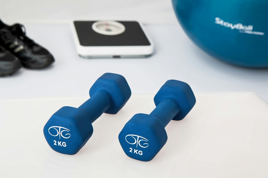 Jillian Michaels Body Revolution Close Up of Dumbbells, a Scale, and a Medicine Ball