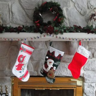 Stocking Stuffers for Men Three Stockings Hanging on a Fireplace