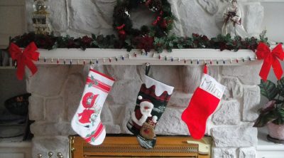 Stocking Stuffers for Men Three Stockings Hanging on a Fireplace