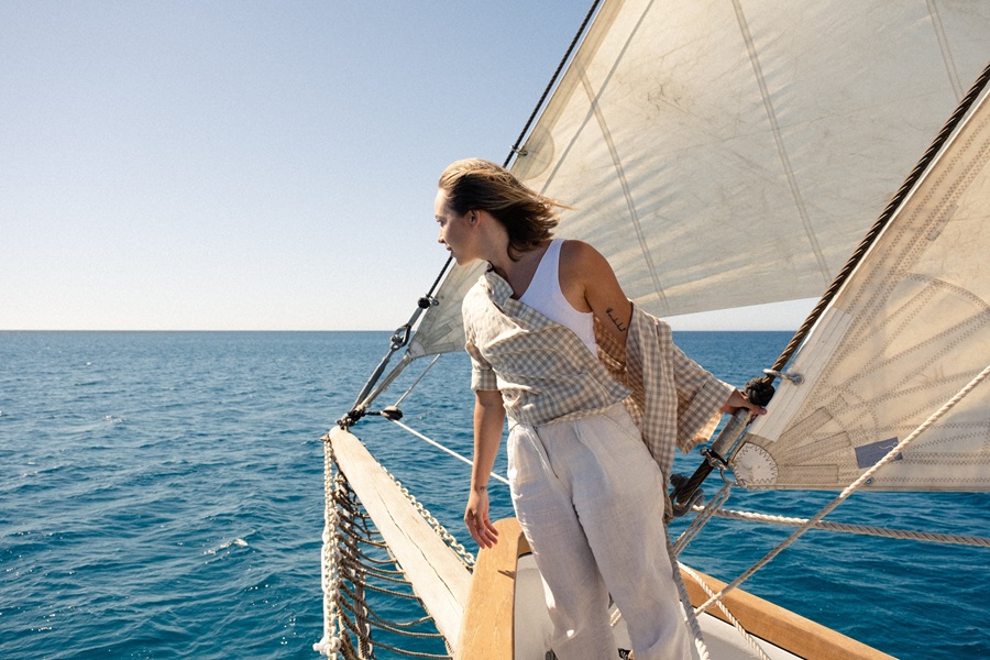 Boating Guide to Newport Harbor Guest Slips a Woman Standing on a Boat as it Sails