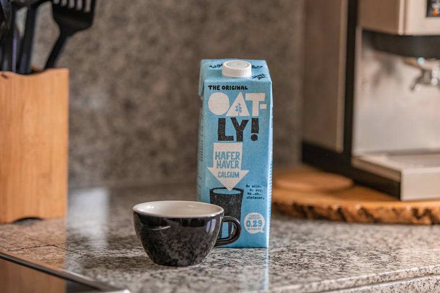 No Dairy Diet A Carton of Oat Milk Next to a Cup of Coffee