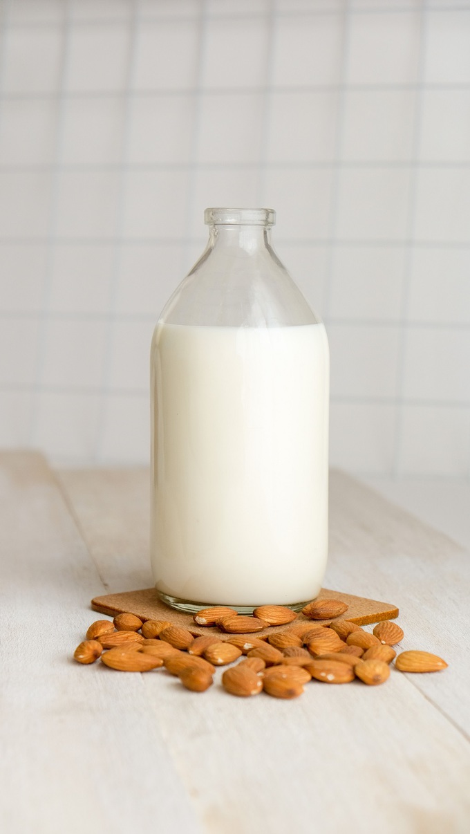 No Dairy Diet a Jug of Almond Milk with Almonds Around It