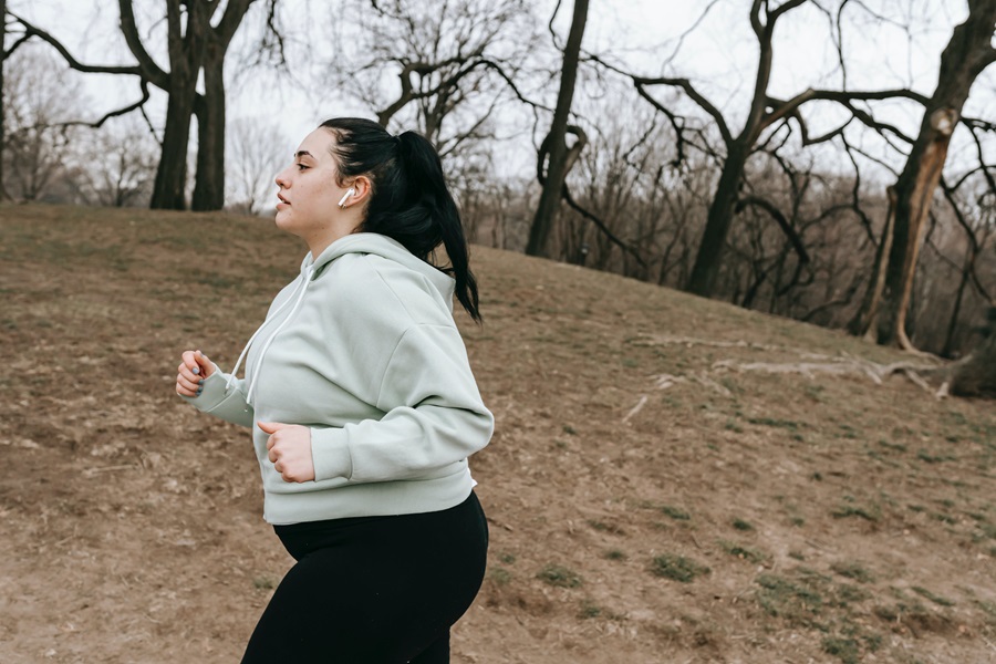 Printable Bodyshred Workout Plan a Woman Jogging on a Path Outside