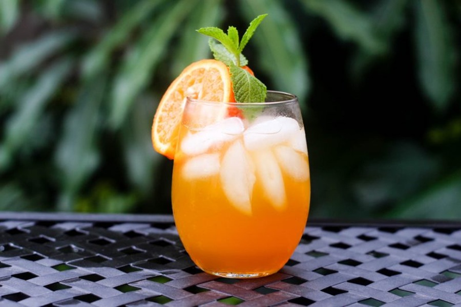 Easy Fireball Cocktail Recipe Sitting on a Black Metal Table Outside