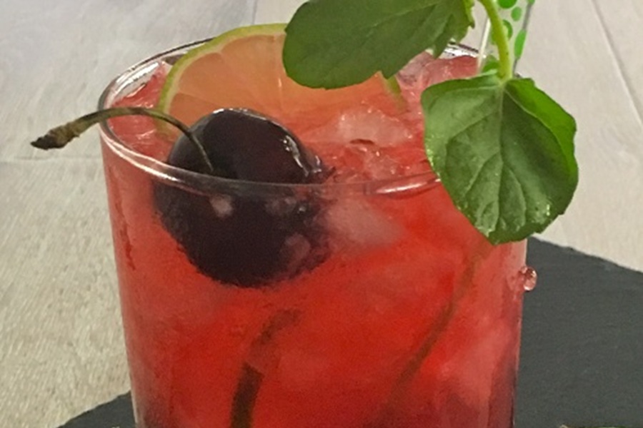 Homemade Blackberry Mojito Recipe Close Up of a Cherry in a Blackberry Mojito with a Lime Slice and a Bit of Mint