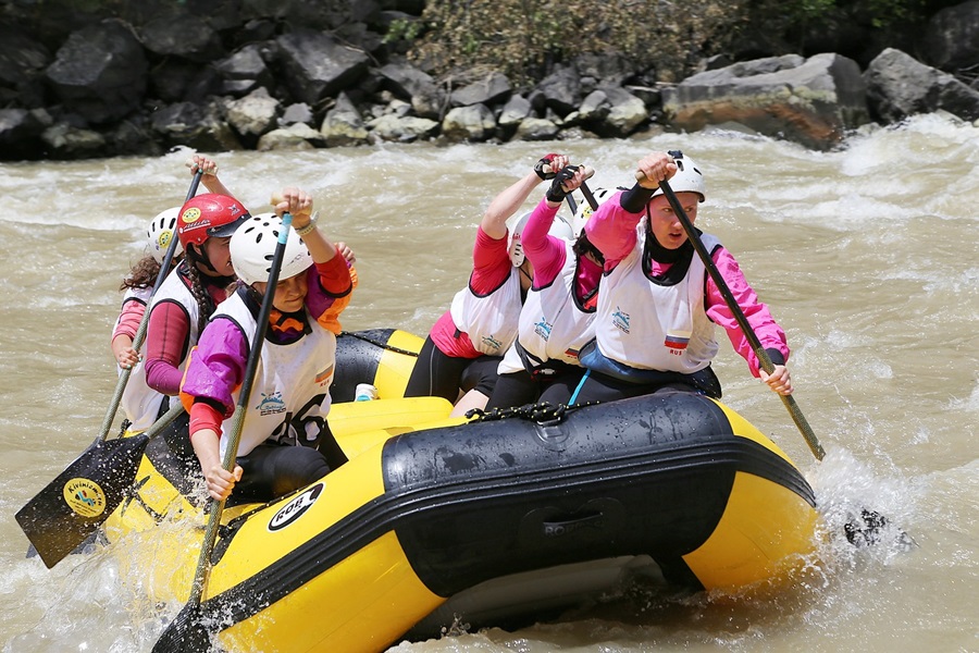 Whitewater Rafting Terms and Lingo To Know Close Up of a Yellow Raft on a River Filled with People