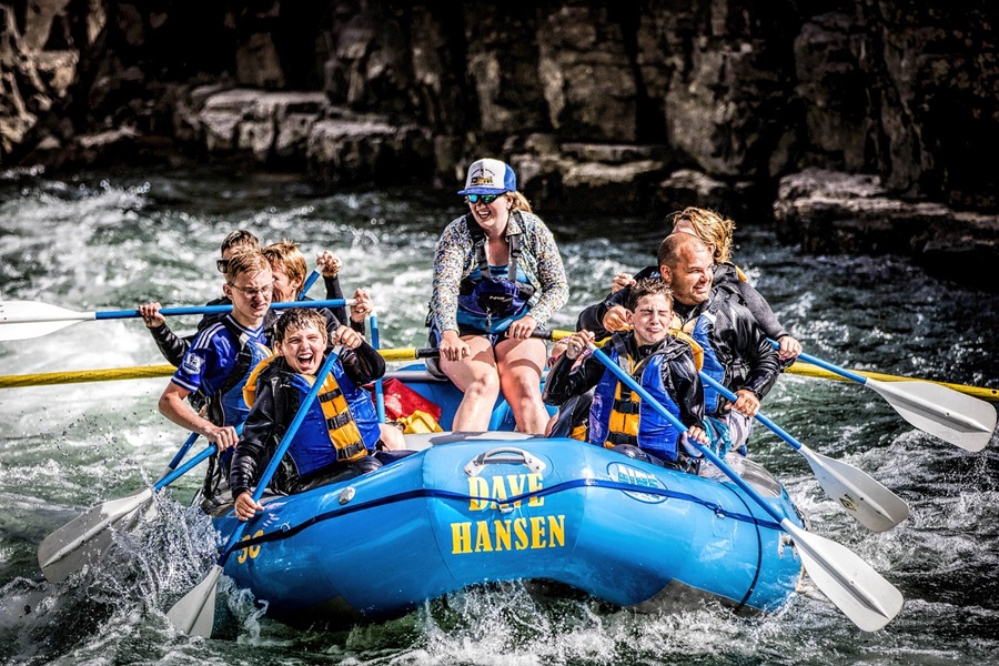 Whitewater Rafting Terms and Lingo To Know People in a Blue Raft Going Down River