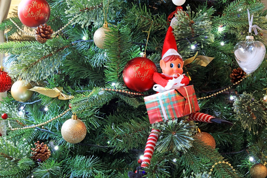 DIY Elf on the Shelf Clothes Close Up of an Elf Sitting in a Christmas Tree