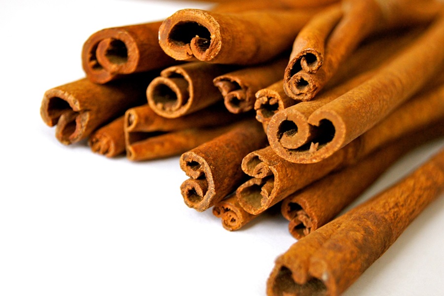 Slimming Foods To Eat Close Up of Cinnamon Sticks on a White Background