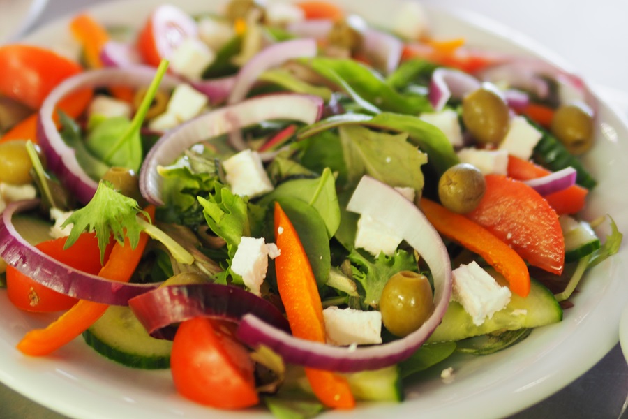 Core De Force Meal Plan Tips Close Up of a Salad with Onions, Cheese, Tomatoes, and Peppers