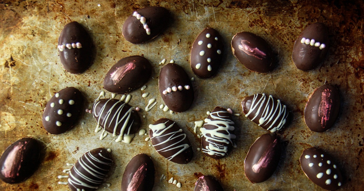 Dairy Free Easter Candy Cashew Butter Chocolate Eggs with White Chocolate Drizzle on a Metallic Surface