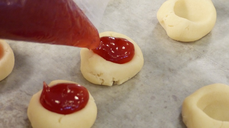 Our raspberry thumbprint cookies recipe is easy to make and the most popular cookie recipe EVER! They make the perfect dessert for parties, holiday gathering, and will be requested time and time again! Cookie Recipes | Thumbprint Cookie Recipes | What are Thumbprint Cookies | How to Make Thumbprint Cookies