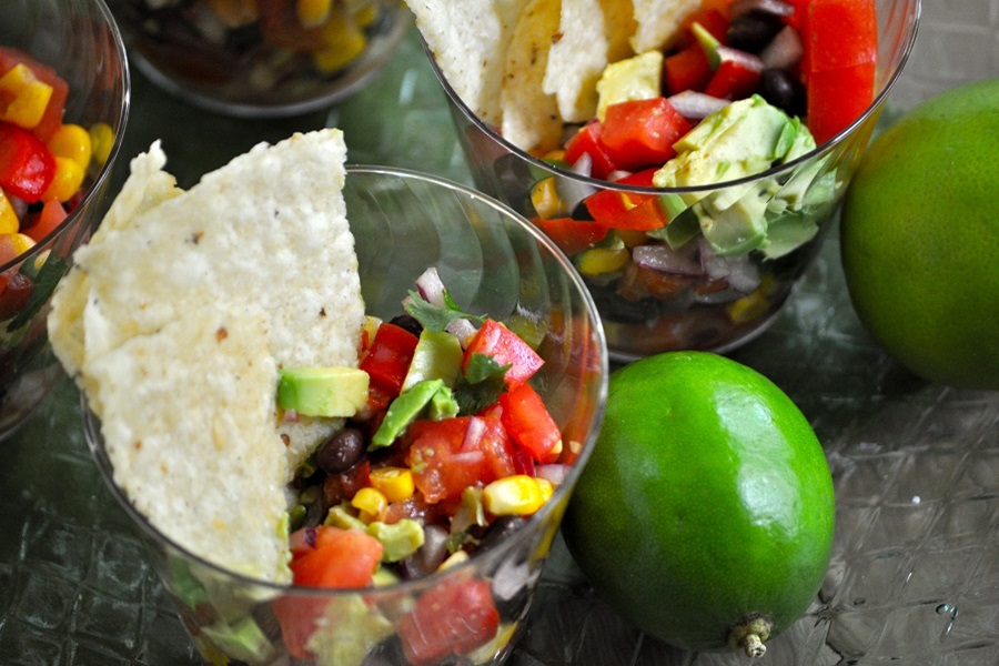 Easy Snacks for Kids Close Up of a Black Bean Salsa Dip in a Plastic Cup with Chips