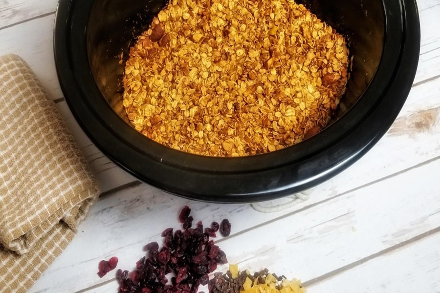 Easy Snacks for Kids a Crockpot of Granola Next to a Pile of Cranberries
