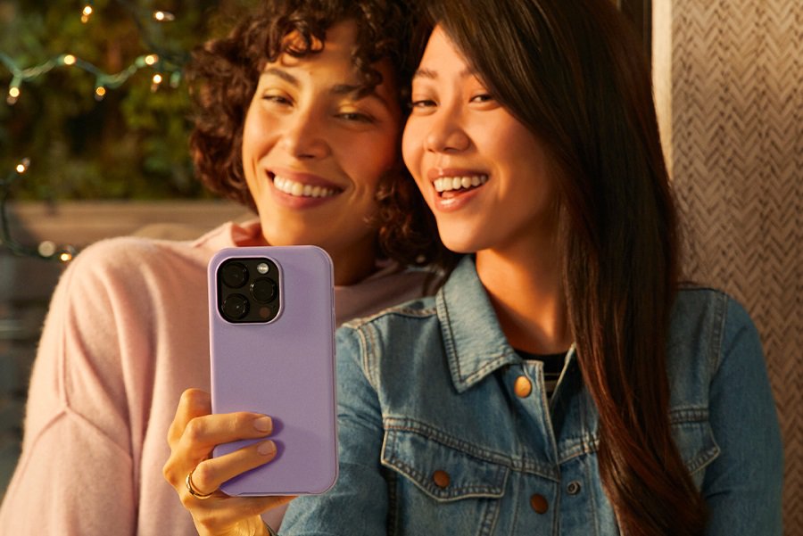 Otterbox Levels of Protection A Woman Holding Up a Phone to Take a Selfie with a Friend