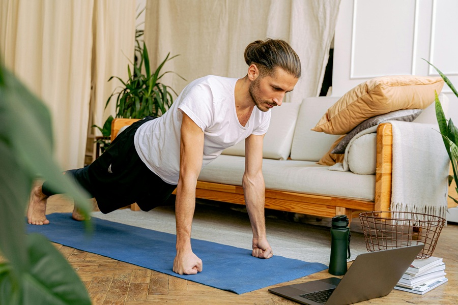 Jillian Michaels Funny Quotes a Man Doing Planks On a Yoga Mat in a Living Room