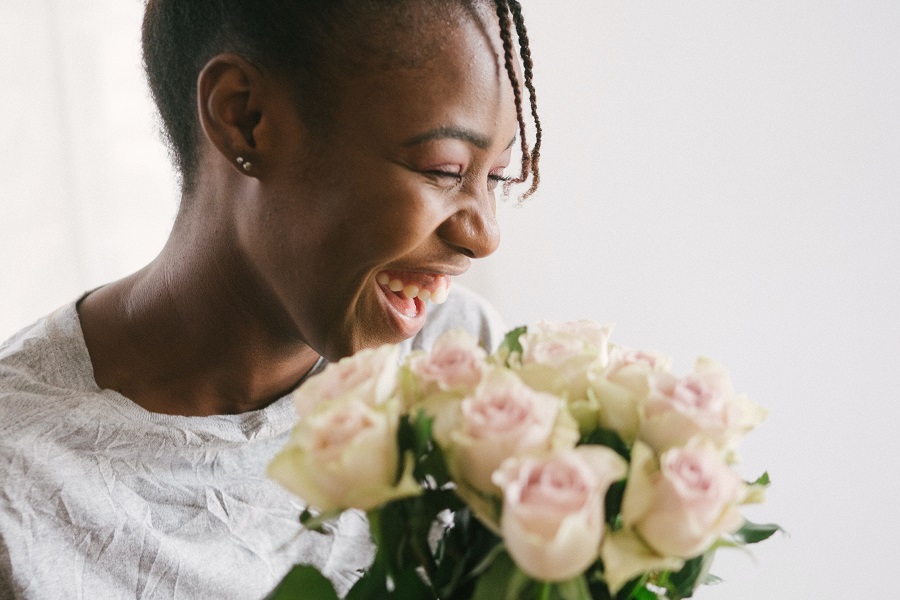 Standard Process Antronex Review and Uses Close Up of a Woman Holding Flowers Smiling
