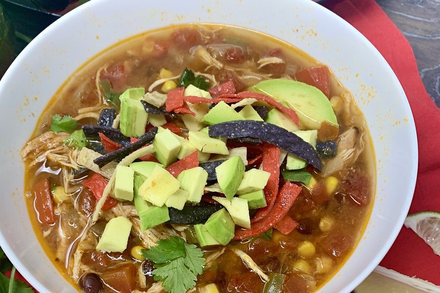 Crockpot Keto Chicken Recipes Close Up of a Bowl of Chicken Tortilla Soup Topped with Tortilla Strips and Avocado