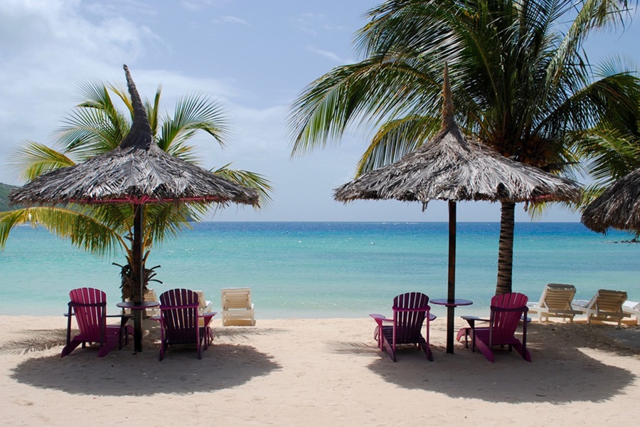 Experience Caribbean Luxury at Sandals Negril Jamaica View of a Beach with Palm Trees and Beach Chairs