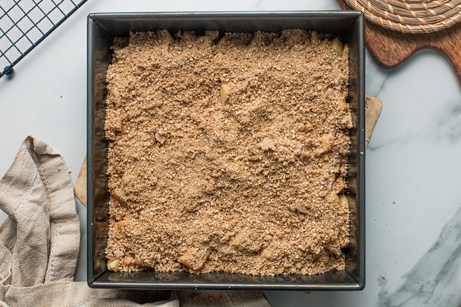 Apple Crisp with Instant Oatmeal Topping Ingredients Layered on the Apples on a Baking Sheet