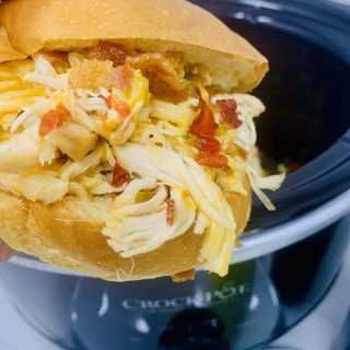 Crockpot Bacon and Chicken Recipe A Chicken Sandwich in Front of a Crockpot