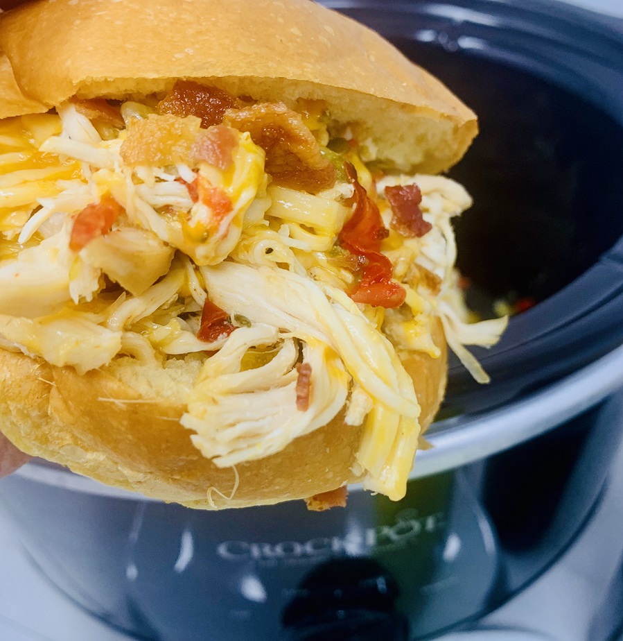 Crockpot Bacon and Chicken Recipe A Chicken Sandwich in Front of a Crockpot