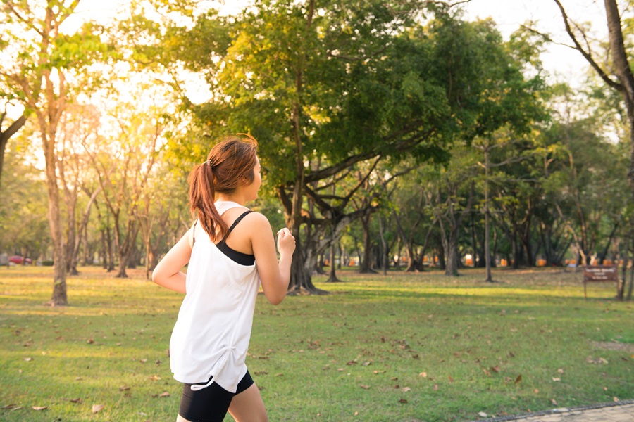 Standard Process Arginex Benefits a Woman Going for a Jog Through a Park