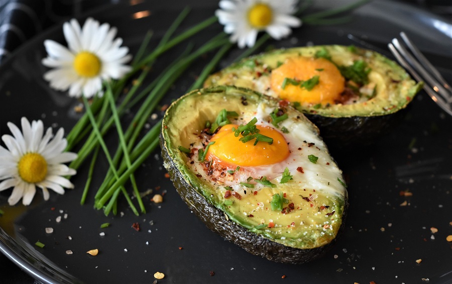 Dairy Free Keto Breakfast Recipes Close Up of an Avocado Cut in Half with Egg Inside