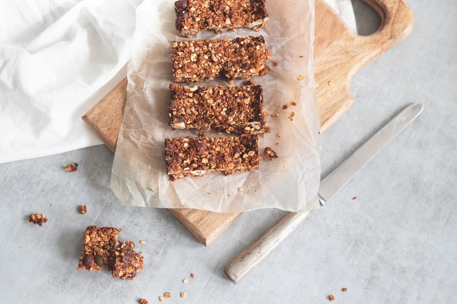 On the Go Keto Snacks Granola Bars on a Cutting Board with a Knife Next to the Board