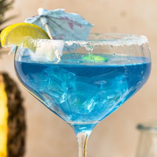 Mermaid Margarita Recipe Close Up of a Blue Margarita in a Glass with Garnish