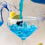 Mermaid Margarita Recipe Close Up of a Margarita Glass with Liquid being Poured Into It