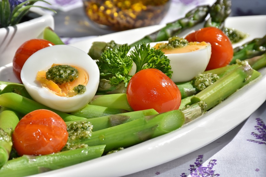 2B Mindset Cost Close Up of a White Serving Platter with Asparagus, Tomatoes, and Hard Boiled Eggs