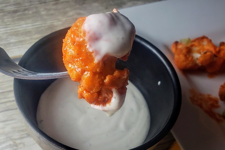 2B Mindset Buffalo Cauliflower Bites Close Up of a Buffalo Cauliflower Bite Dipped in Ranch