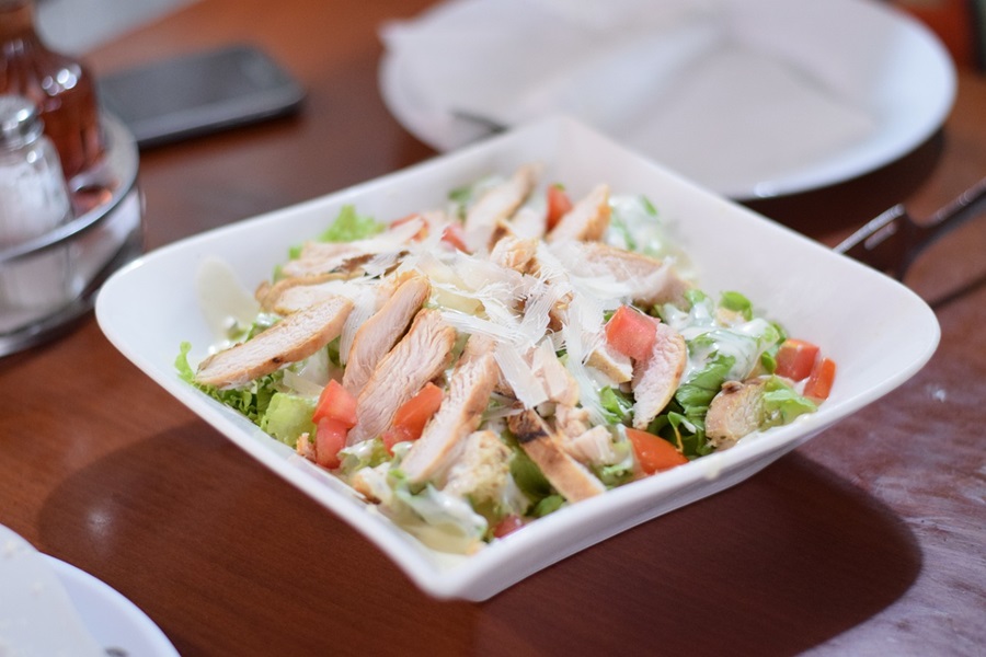 LIIFT4 Meal Plan G Recipes Close Up of a White Bowl of Salad Topped with Chicken Slices