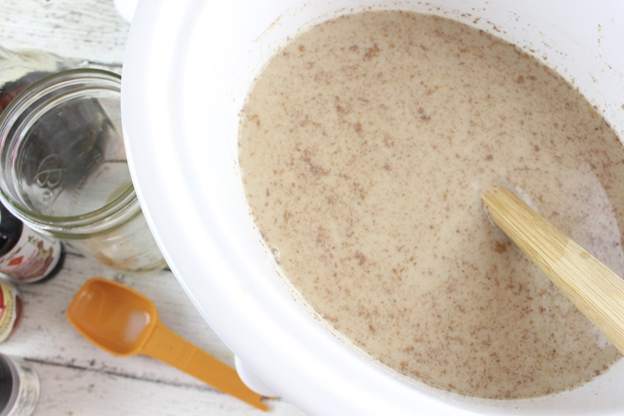Gingerbread Latte Recipe Latte Brewing in an Open Crockpot with a Spoon Sticking Out From the Latte