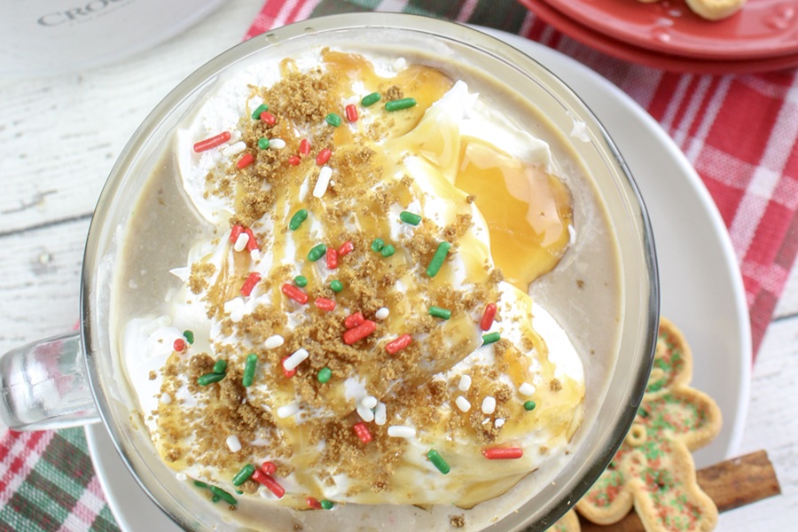 Gingerbread Latte Recipe Close Up View of Whipped Cream Topped with Cookie Crumbs, Sprinkles, and Caramel